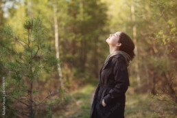 girl woman walking in nature park forest and breathing fresh air. concept of breathing, inhaling, relaxing